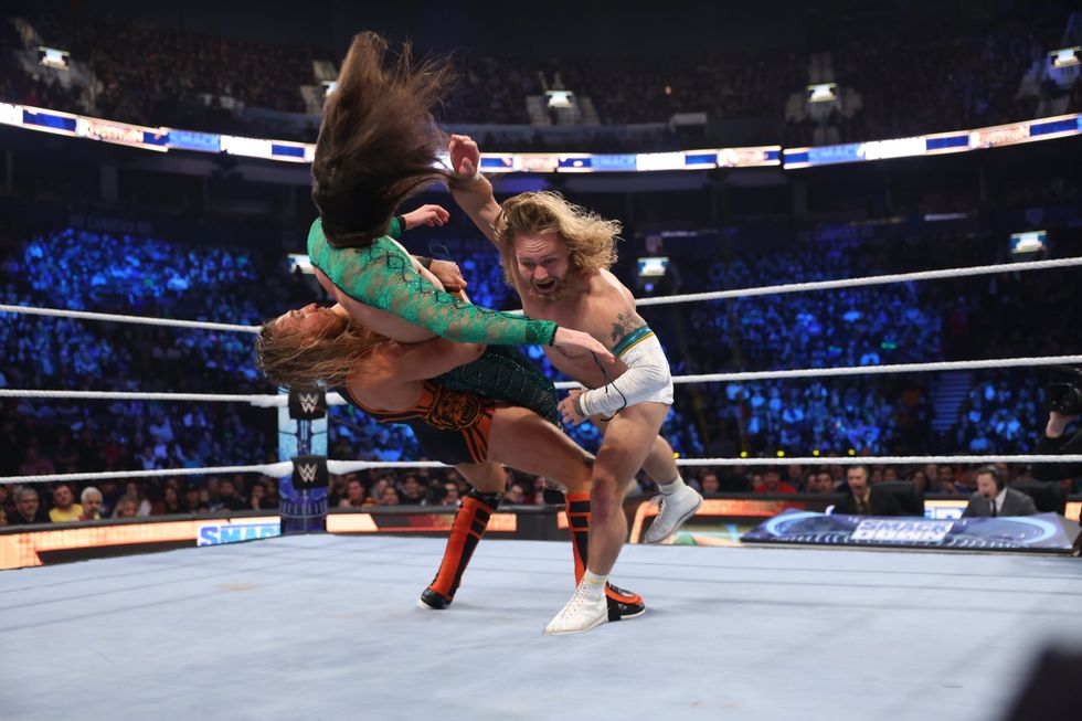 Tyler Bate and Pete Dunne execute a tag team move on the middle of the WWE Smackdown ring