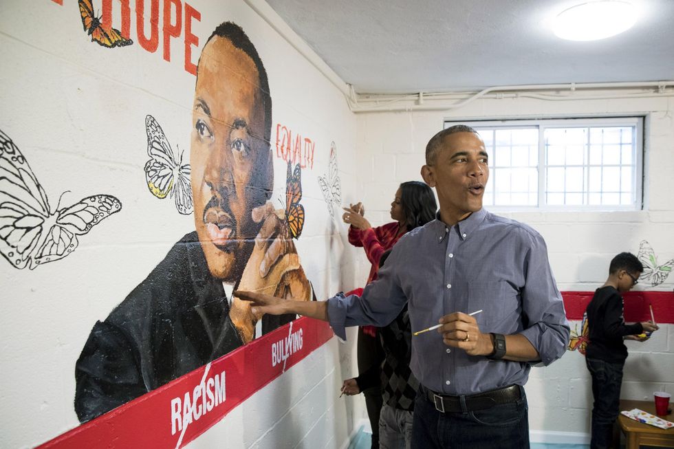 U.S. President Barack Obama (Front) and first lady Michelle Obama (Back) help paint a mural depicting Martin Luther King Jr., at the Jobs Have Priority Naylor Road Family Shelter January 16, 2017 in Washington, DC. President Obama and the First Lady attended a service event at the Jobs Have Priority Naylor Road Family Shelter for Martin Luther King Jr. Day. Picture: