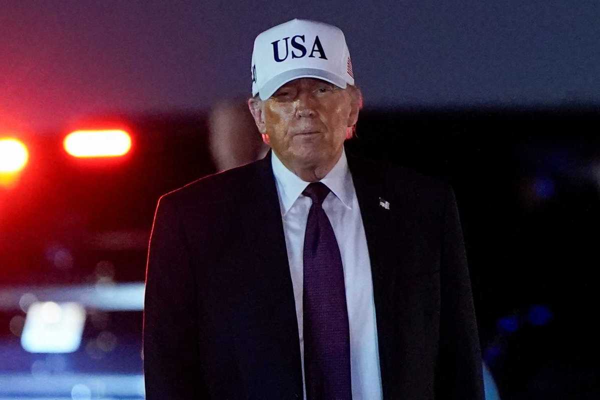 U.S. President Donald Trump looks on after disembarking Air Force One at Palm Beach International Airport in West Palm Beach, Florida, U.S.