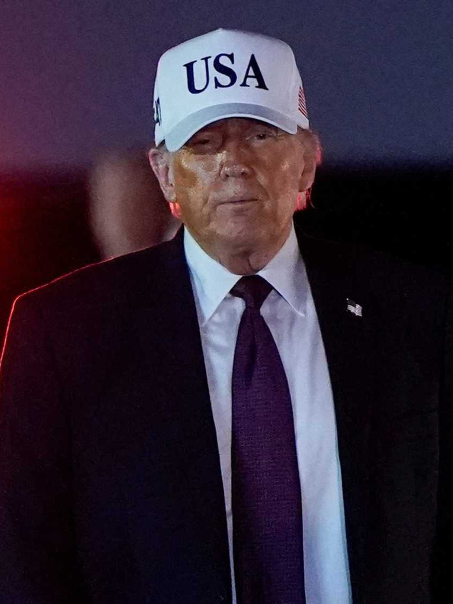 U.S. President Donald Trump looks on after disembarking Air Force One at Palm Beach International Airport in West Palm Beach, Florida, U.S.