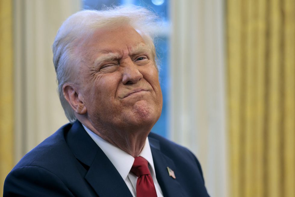 U.S. President Donald Trump reacts to a reporter's question from the Resolute Desk after signing an executive order to appoint the deputy administrator of the Federal Aviation Administration in the Oval Office at the White House on January 30, 2025 in Washington, DC