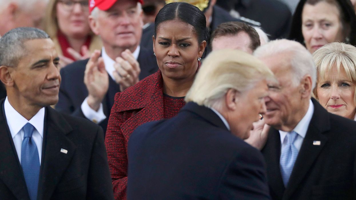 U.S. President Donald Trump shakes hands with outgoing U.S. Vice President Joe Biden as outgoing President Barack Obama and Michelle Obama look on