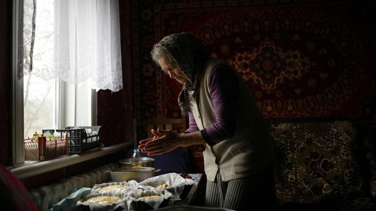 Heartbreaking moment a defiant Ukrainian grandma bakes cakes among the rubble