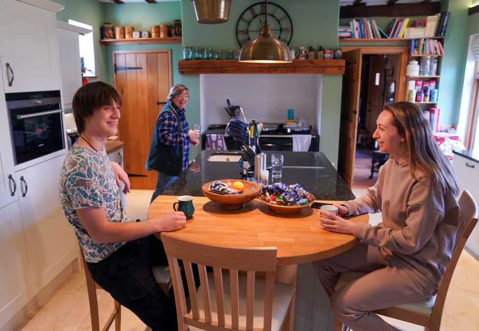 Ukrainian refugees Yaroslav Kryvoshyia (left) and Irina Kryvoviaz (right) with their host Sarah Allen-Stevens (centre) as they settle into their new home in North Moreton, Oxfordshire