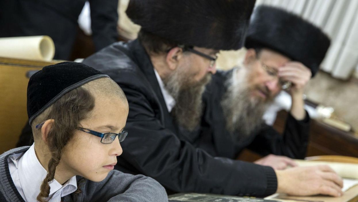 Ultra-Orthodox Jews reading at a synagogue.