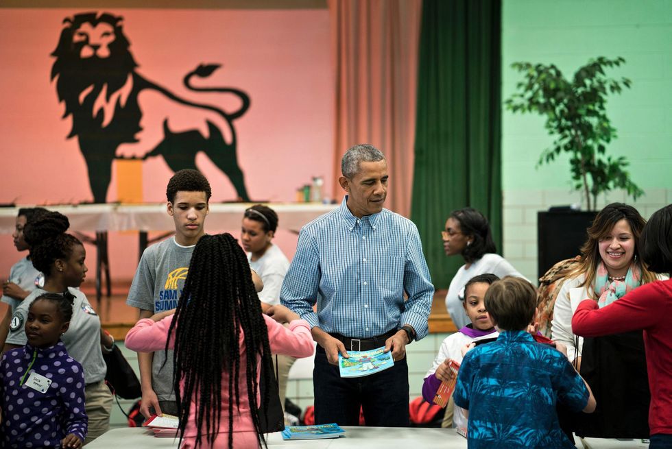 US President Barack Obama helps give out books at Leckie Elementary School while celebrating Martin Luther King Day January 18, 2016 in Washington, DC. The President and First Lady Michelle Obama participated in the community service project in celebration of the Martin Luther King Day of Service and in honor of Dr. Kings life and legacy. Picture: