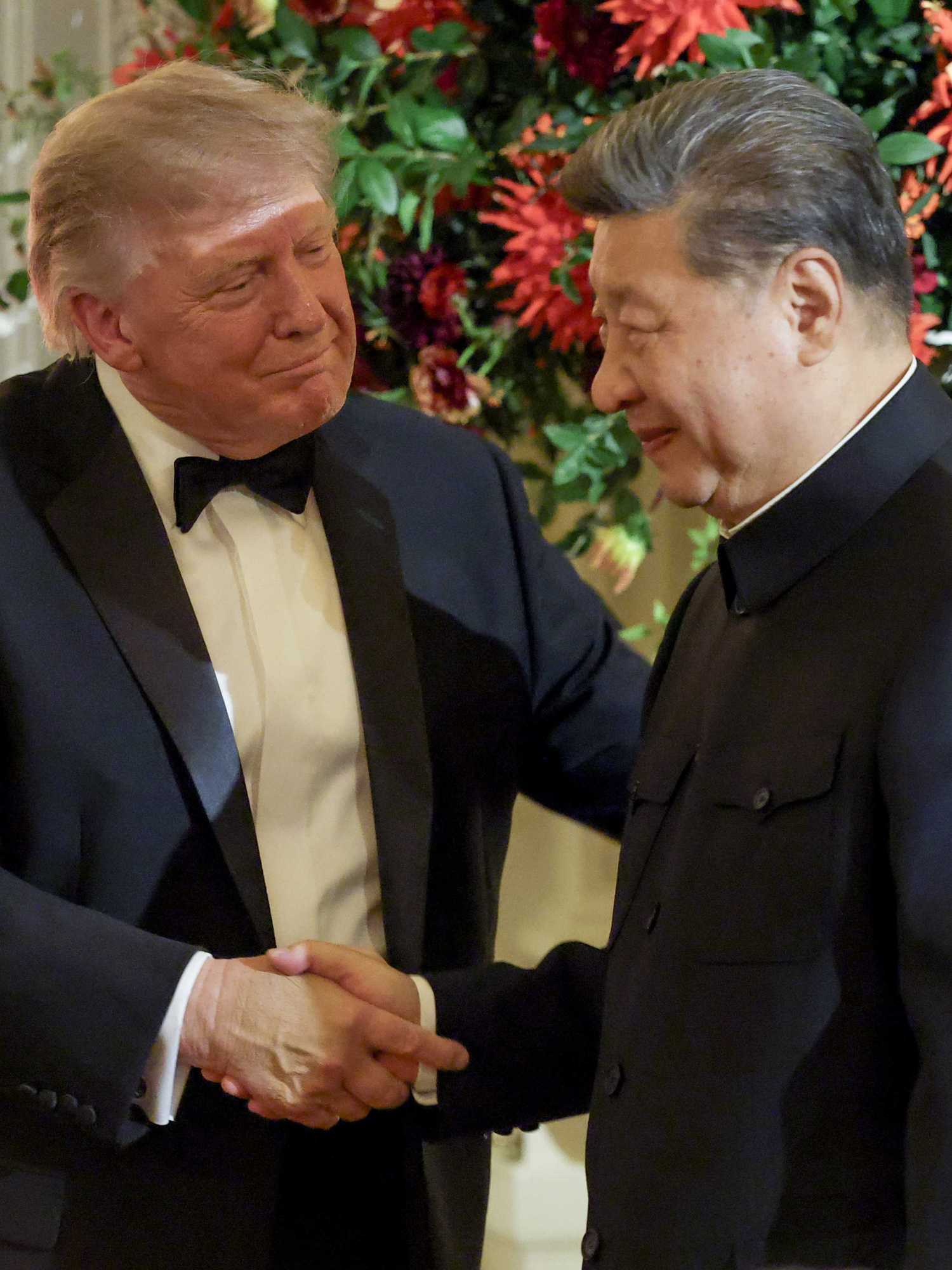 US president Donald Trump shakes hands with Xi Jinping during a state dinner.