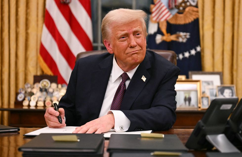 US President Donald Trump signs executive orders in the Oval Office of the White House in Washington, DC, on January 20, 2025