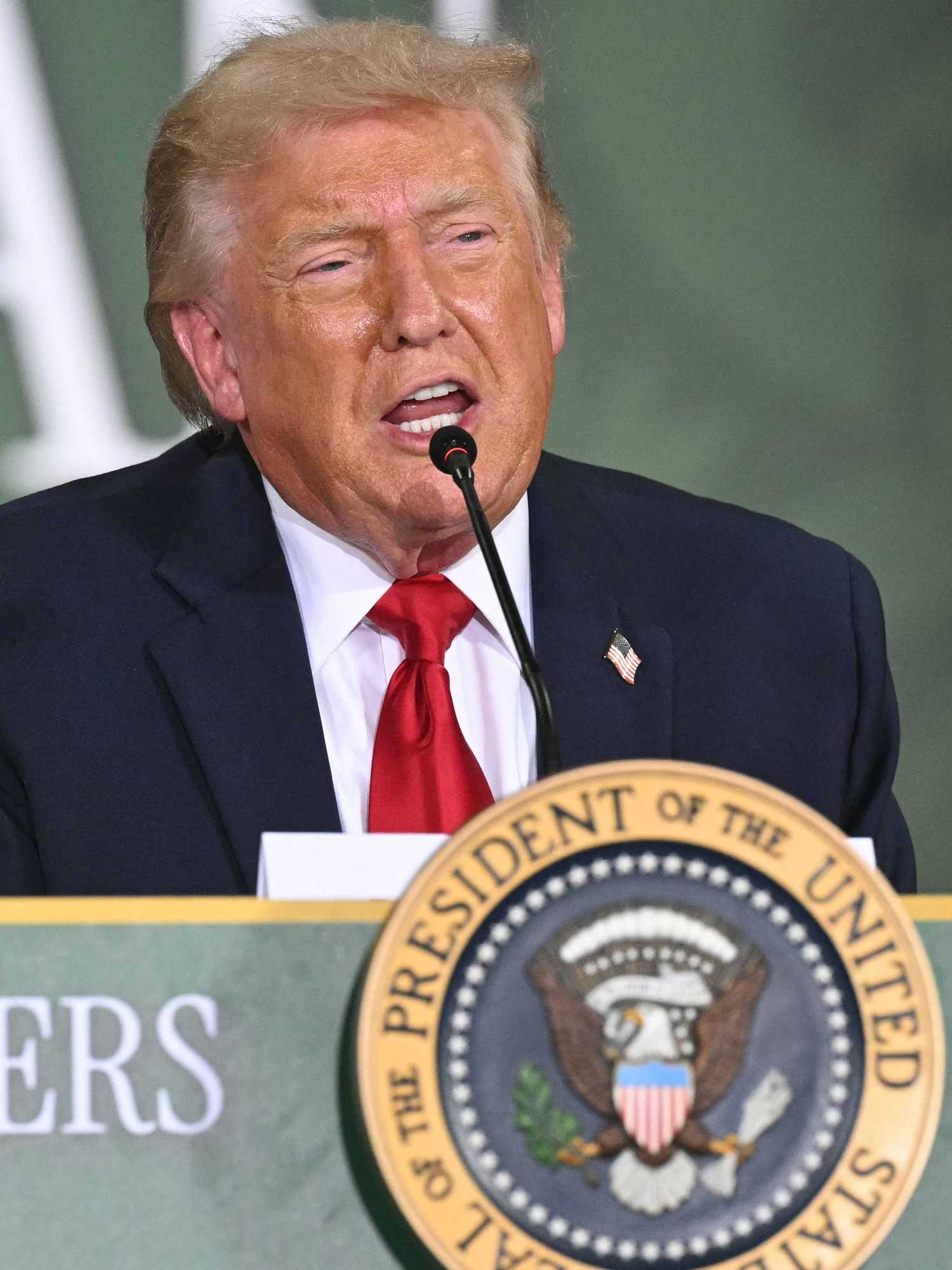 US president Donald Trump speaks behind a table at an agriculture roundtable in Wisconsin.