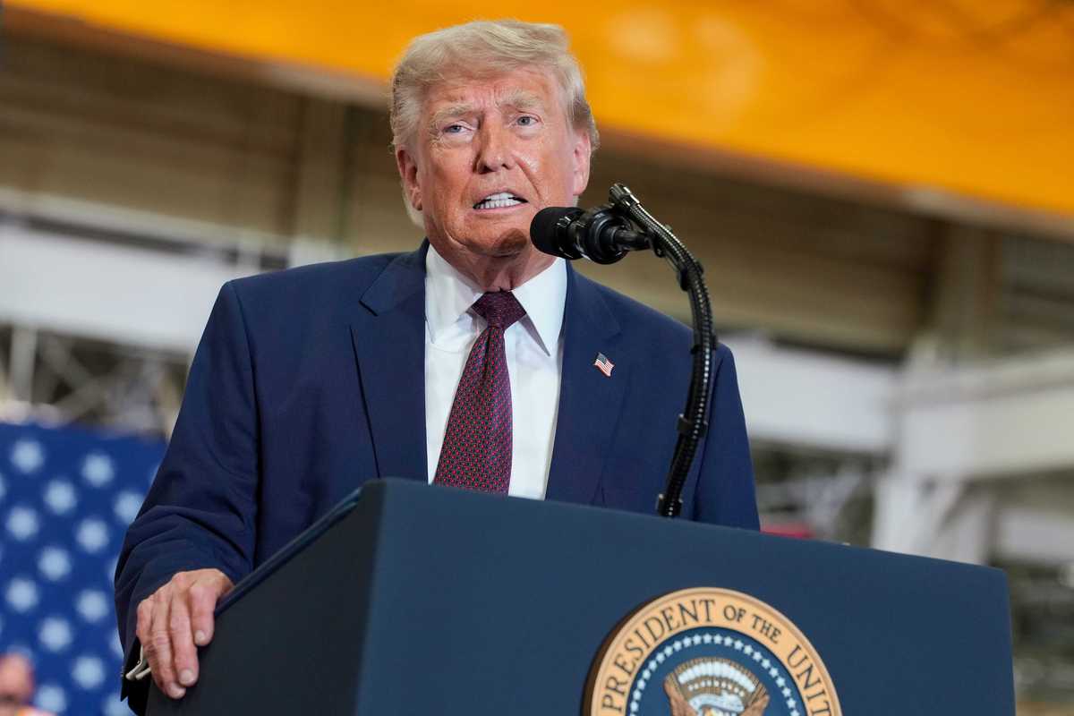 US president Donald Trump speaks behind the presidential lectern at an event.