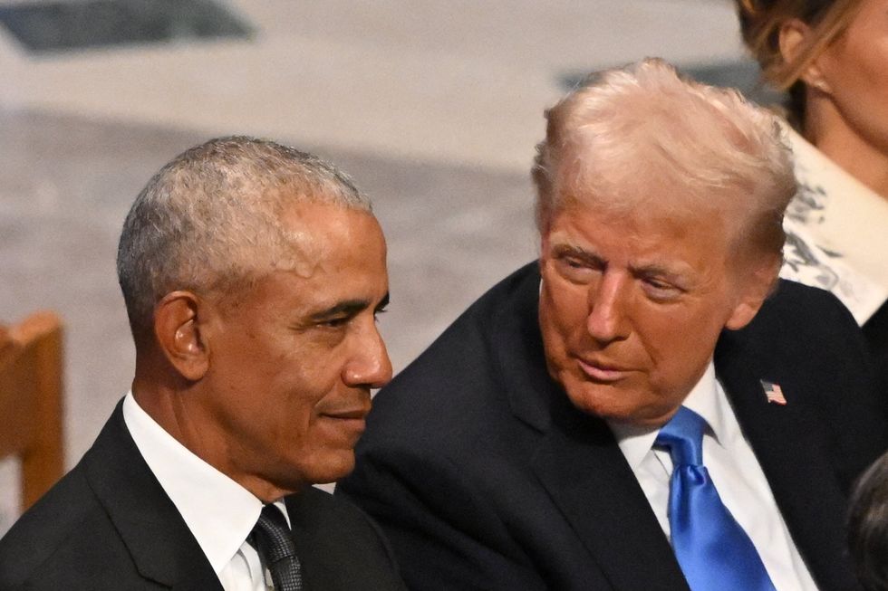 US President-elect Donald Trump speaks with former President Barack Obama as they attend the State Funeral Service for former US President Jimmy Carter at the Washington National Cathedral in Washington, DC, on January 9, 2025