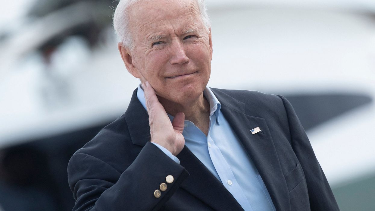 <p>US President Joe Biden wipes his neck after a cicada landed on him while boarding Air Force One </p>