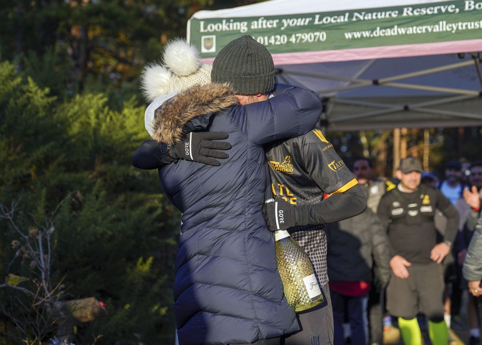 Veteran Brian Wood MC hugs his partner Lucy (Steve Parsons/PA)