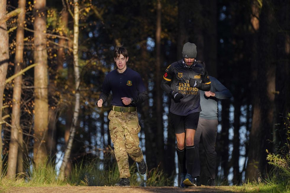 Veteran Brian Wood MC (right) with his son Bailey (left) (Steve Parsons/PA)
