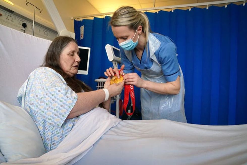 Vicky Wright shows patient Mary Telford her medal