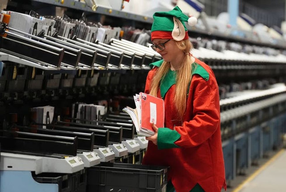 Victoria McDonald sorts letters dressed as an elf