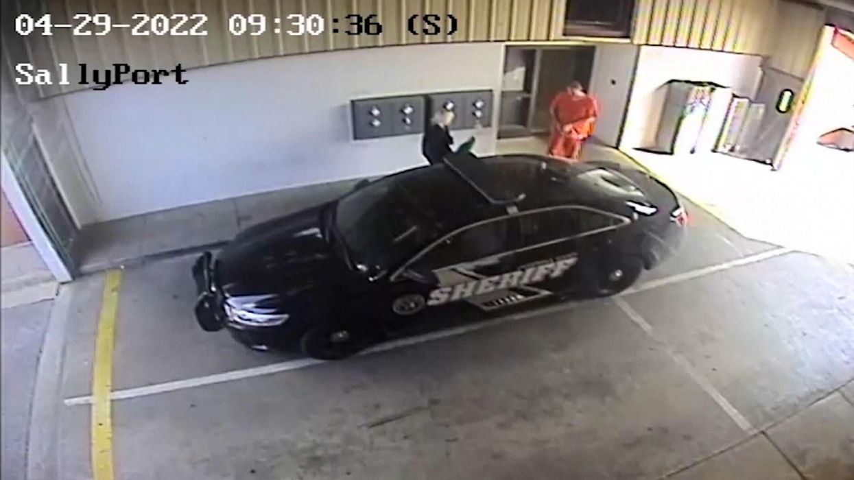 Prison officer seen on CCTV sneaking confessed murderer out of jail