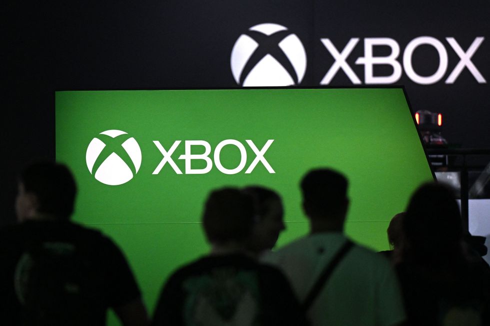 Visitors stand at the Xbox booth at the Gamescom video game fair in Cologne, western Germany, on August 23, 2023. According to the organisers, around 1,100 exhibitors from 53 countries will be presenting their products during the fair running until August 27, 2023