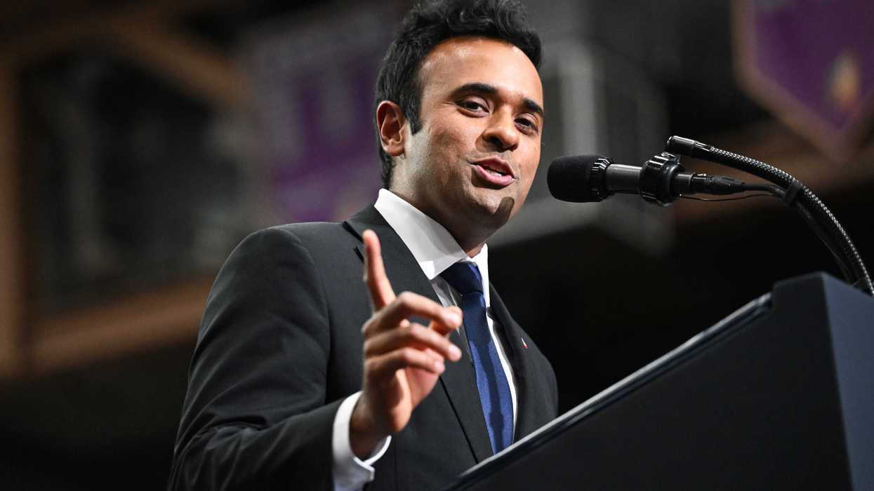Vivek Ramaswamy speaking into a microphone while standing behind a lectern.