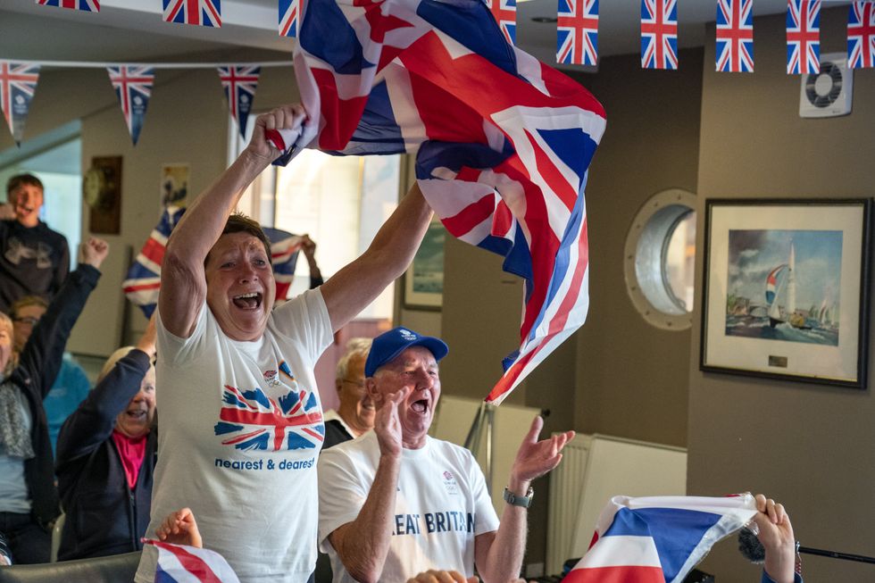 Vivian and Leslie Bithell celebrate their son Stuart Bithell and his helm Dylan Fletcher winning a gold medal (Peter Byrne/PA)
