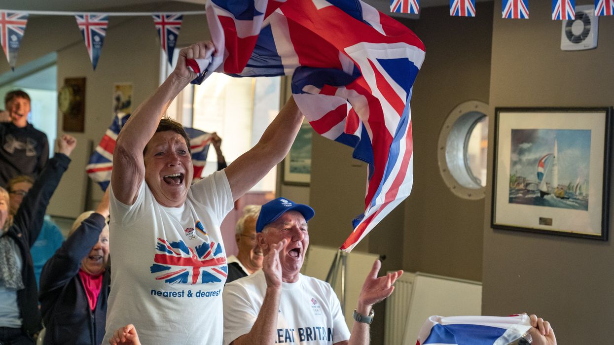 Vivian and Leslie Bithell watch their son Stuart Bithell and his helm Dylan Fletcher win a gold medal in the 49er medal race (Peter Byrne/PA)