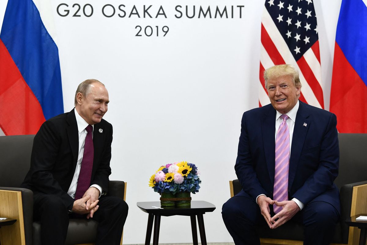 Vladimir Putin, left and smiling, sits opposite Donald Trump, right, also smiling, at the G20 Osaka Summit 2019.