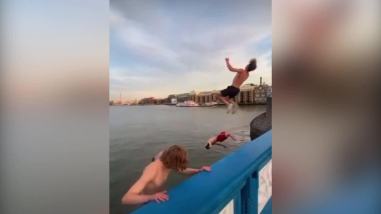 Daredevils backflip 30ft off Tower Bridge into Thames to cool off from heatwave
