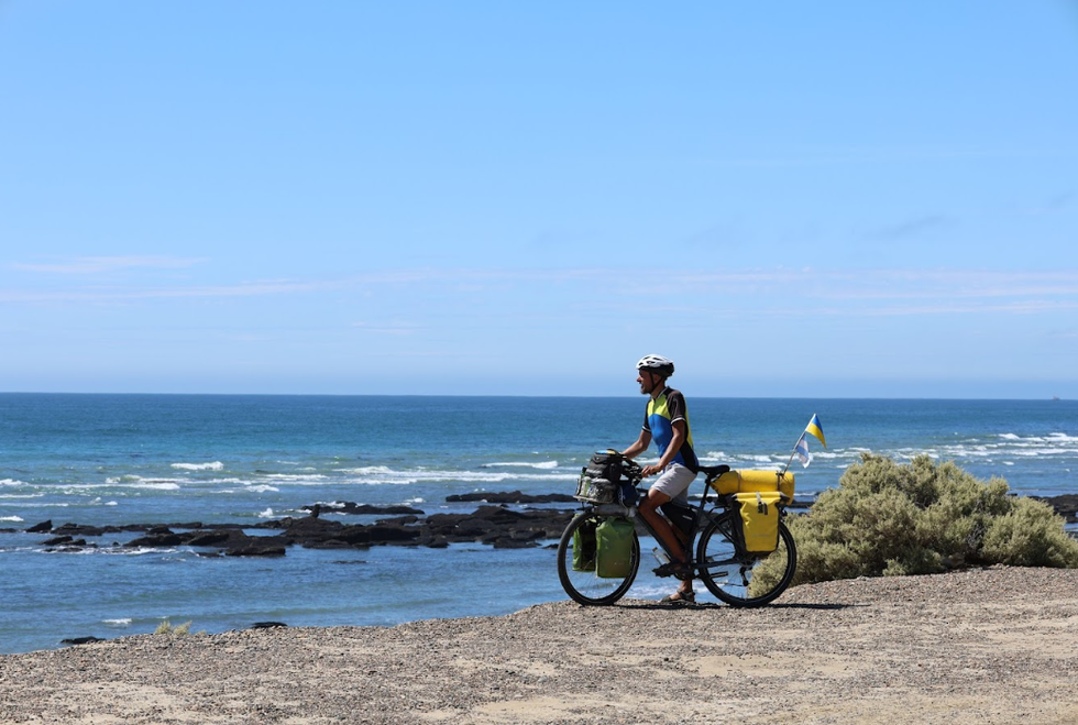Volodymyr Muliar pictured cycling near a beach