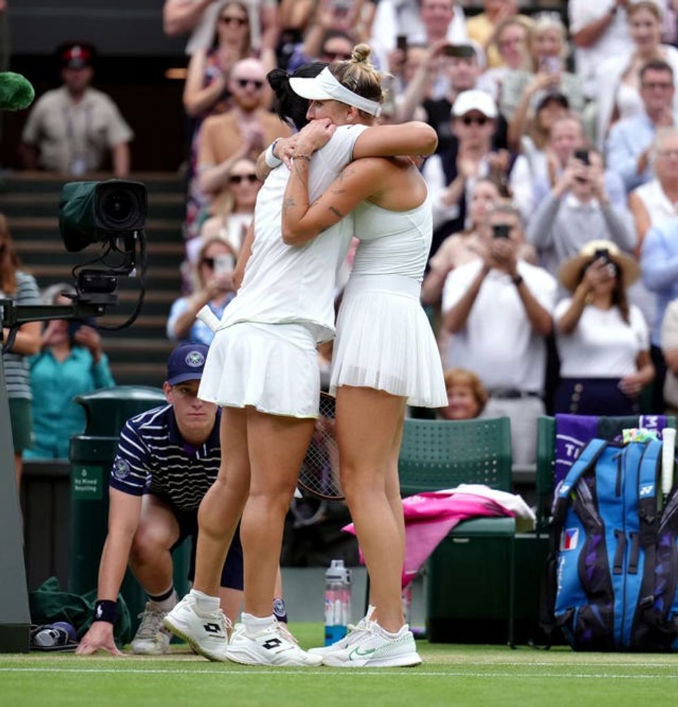 Vondrousova and Jabeur hugging on court