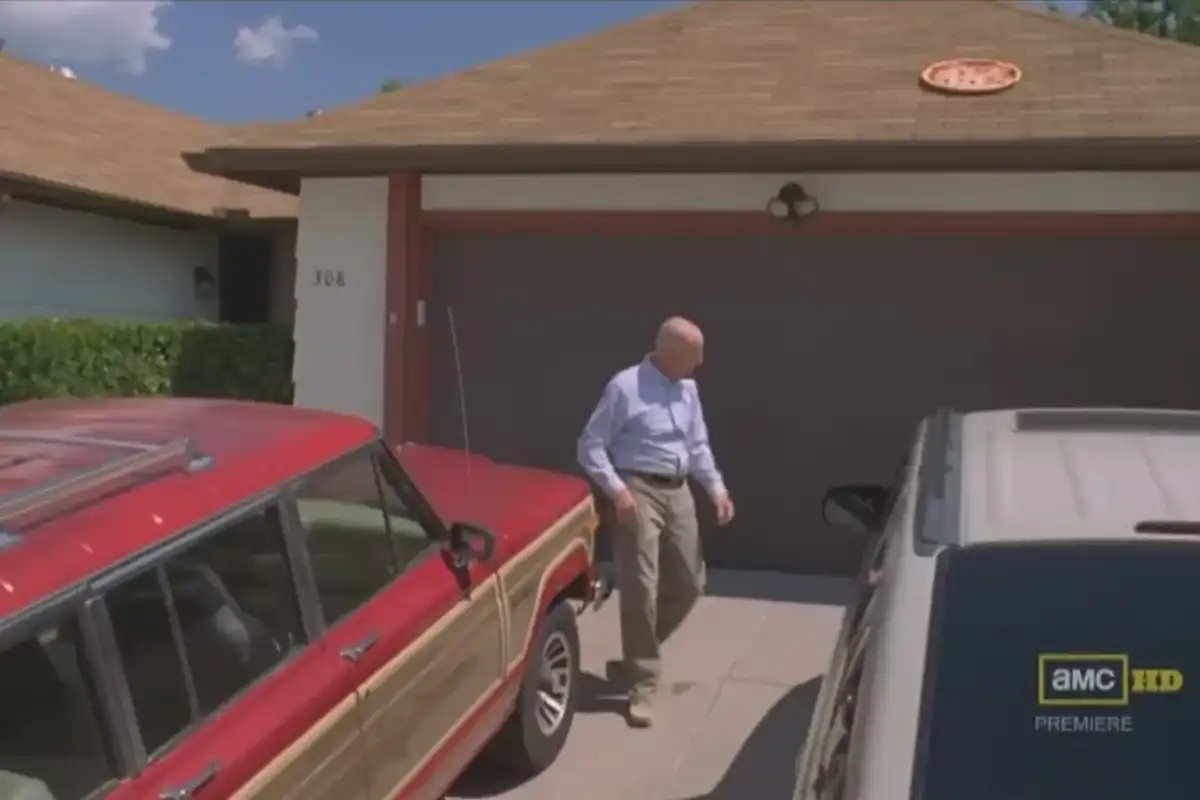 Walter White looks at the pizza he threw on his roof