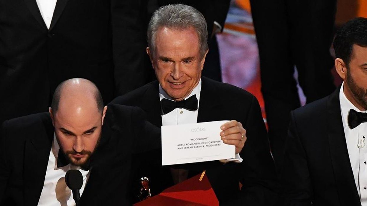 Warren Beatty holding up Moonlight's winning card
