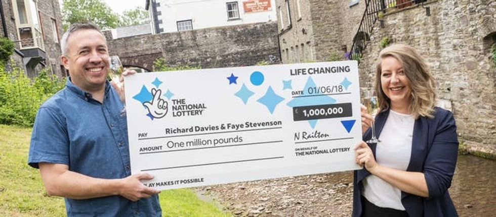 Welsh couple holding first winning Lottery cheque