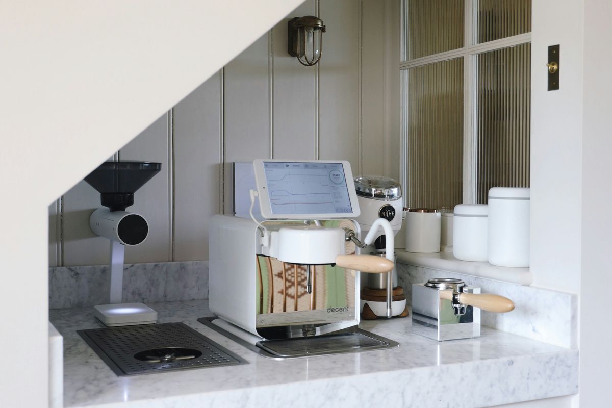 White and black microwave oven on white wooden kitchen cabinet