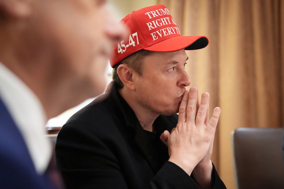 White House Senior Advisor, Tesla and SpaceX CEO Elon Musk (L) listens during a cabinet meeting held by U.S. President Donald Trump at the White House on March 24, 2025 in Washington, DC