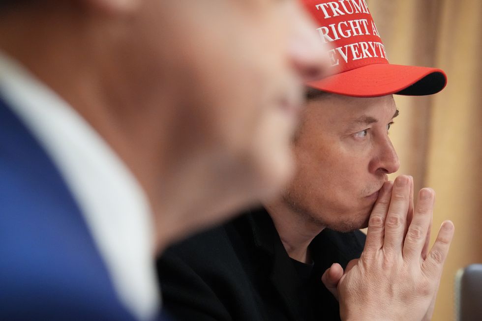 White House Senior Advisor, Tesla and SpaceX CEO Elon Musk (L) listens during a cabinet meeting held by U.S. President Donald Trump at the White House on March 24, 2025 in Washington, DC