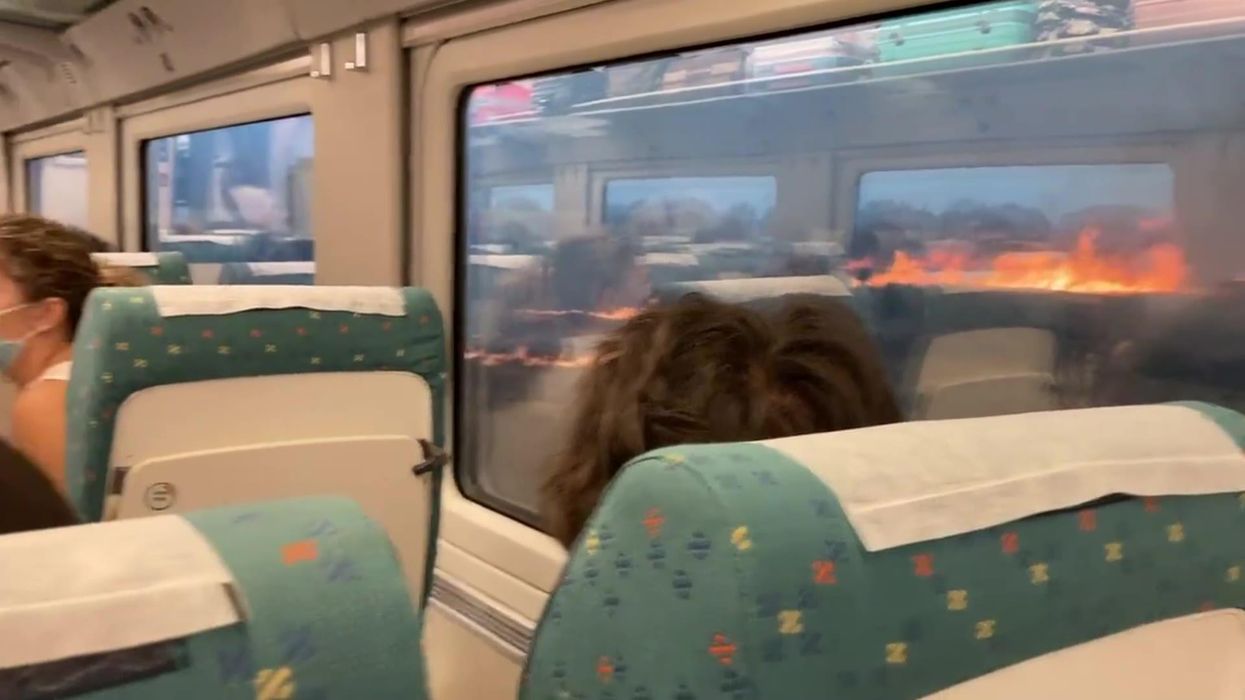 Terrifying footage sees wildfire raging outside of train
