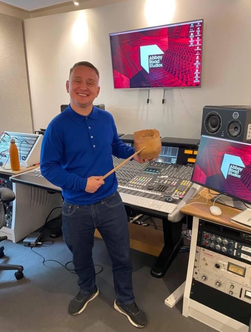 Wilfy Williams inside Abbey Road Studios with recording equipment behind him