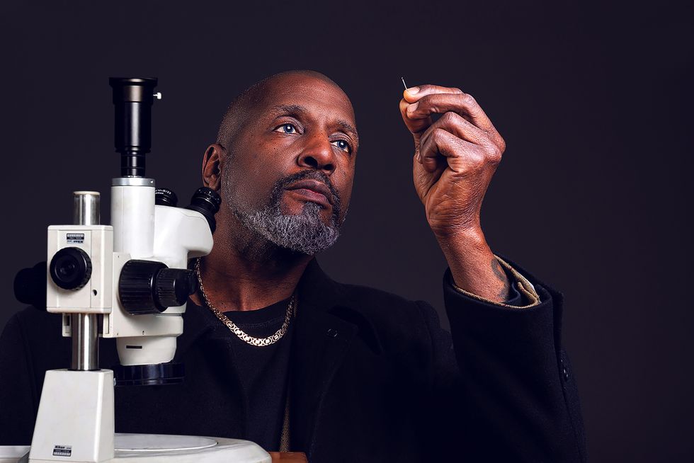 Willard Wigan MBE looking through the eye of a needle