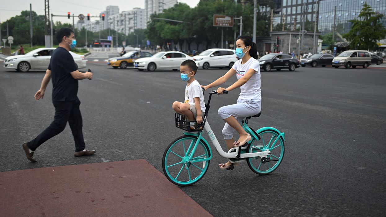 Woman and child on bike in Beijing