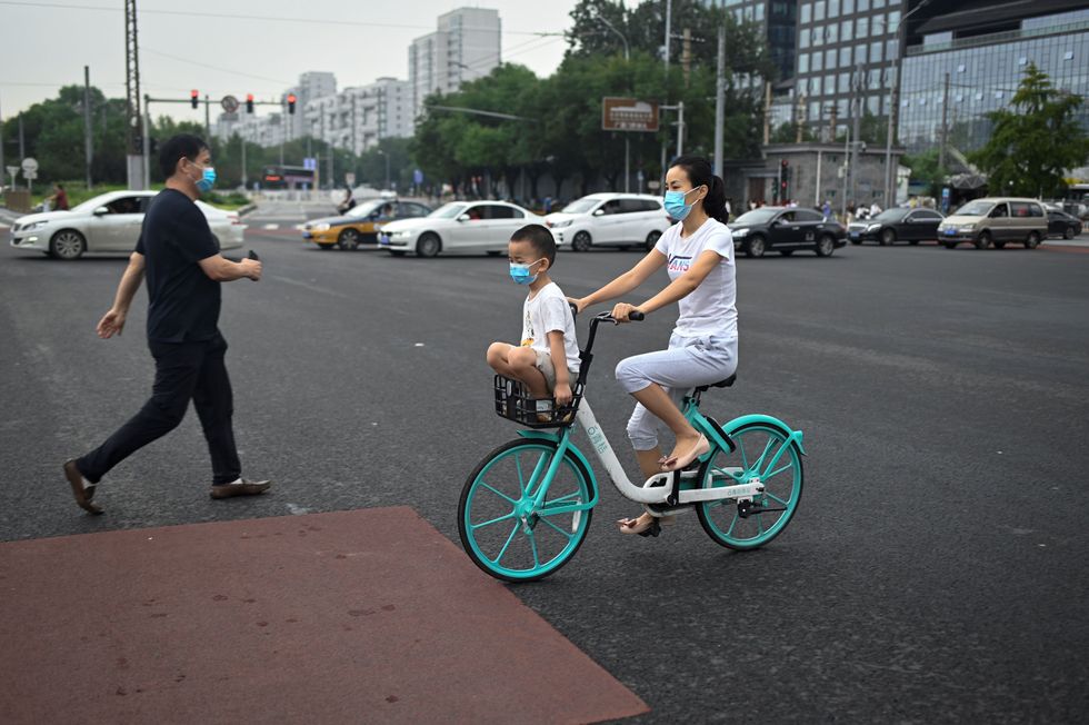 Woman and child on bike in Beijing