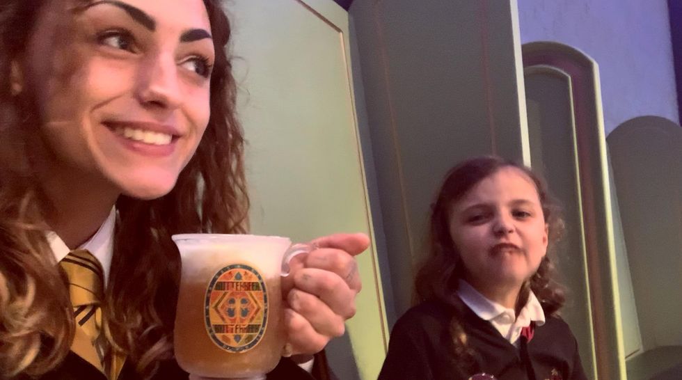 Woman drinking beer and another making a face