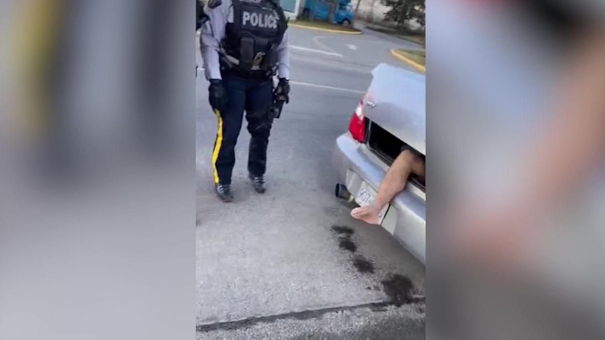 Angry shoppers fence in double parked car with trolleys and call driver a 'douchebag'
