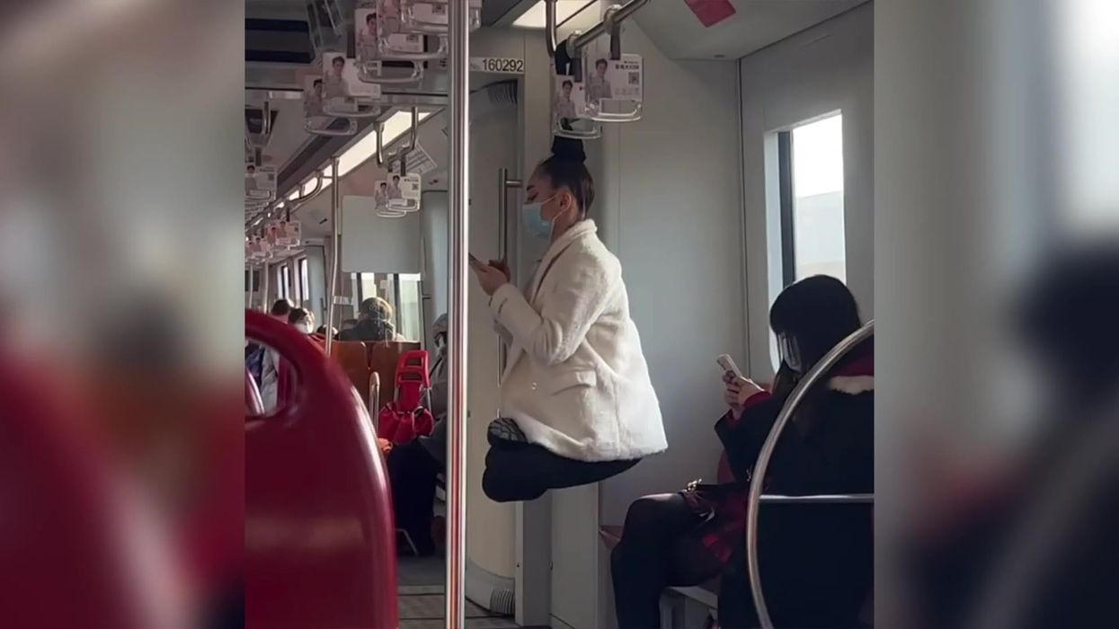 Woman hangs by just her hair on train handrail in astonishing footage