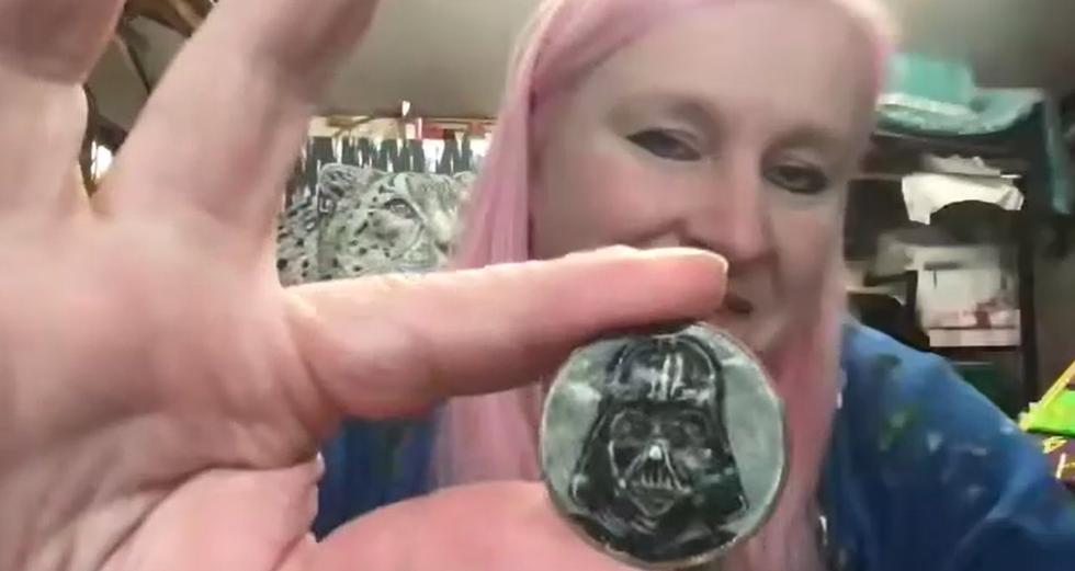 Woman holding up coin