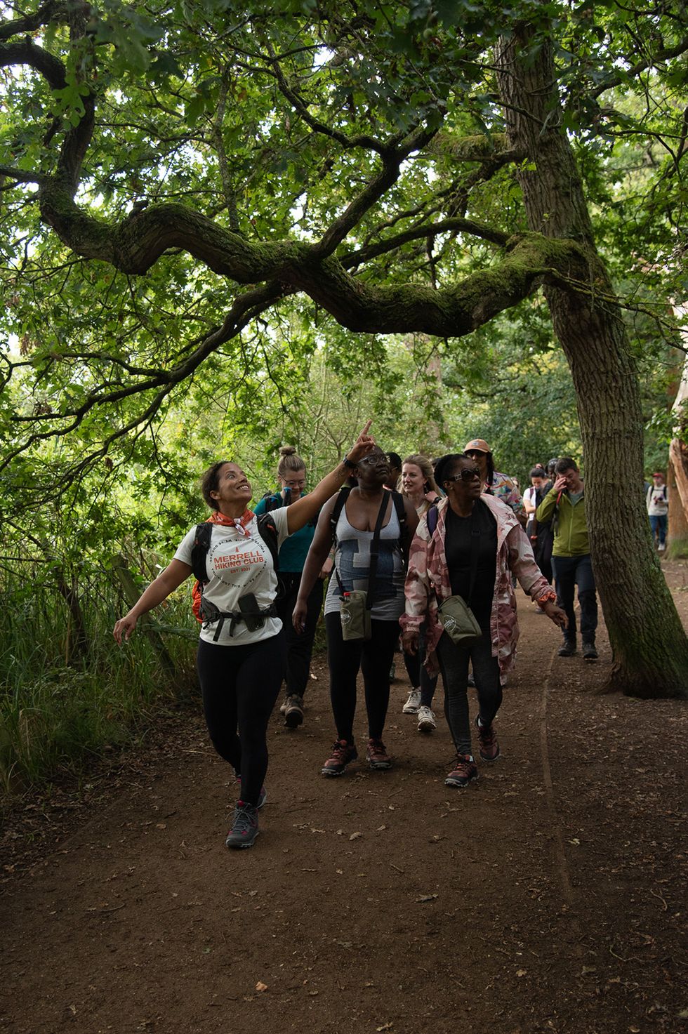Woman leading others through the woods