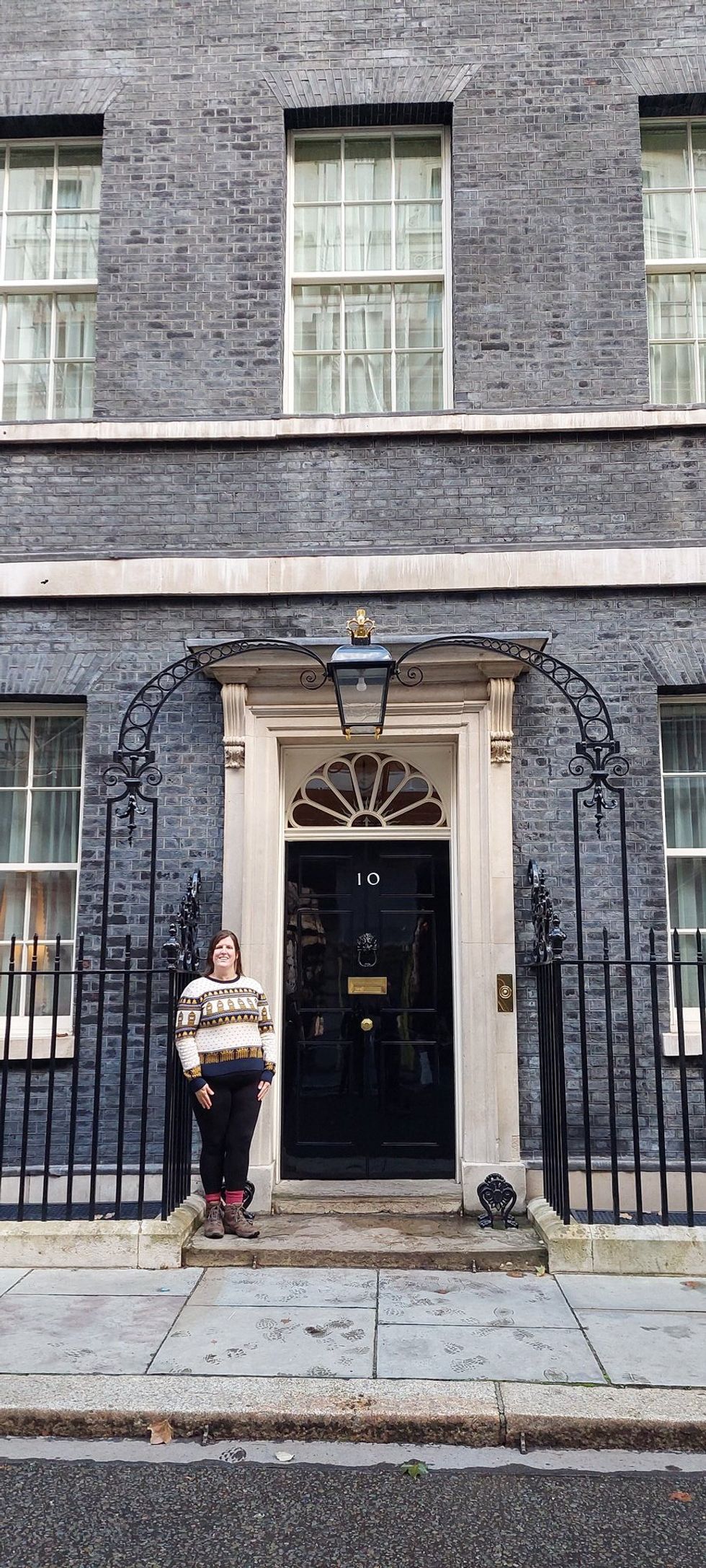 Woman posing outside door