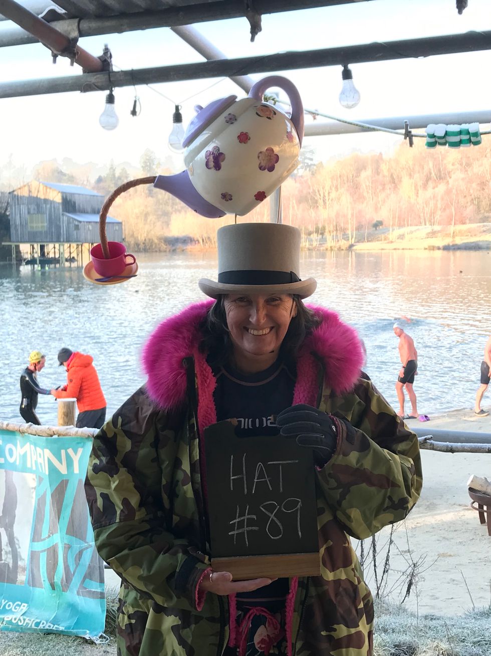 Woman posing with tea pot on her head