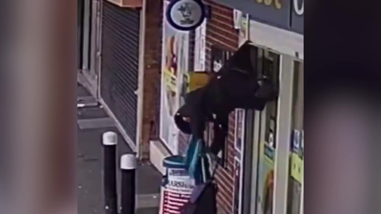Woman saved after shop shutter lifts her into air