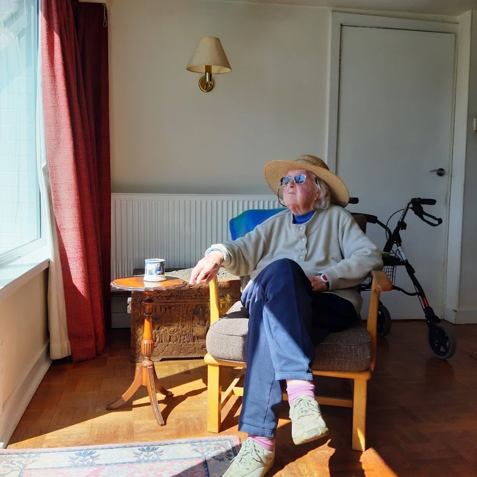 Woman sitting down and looking out of the window