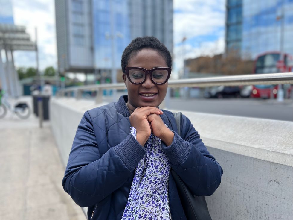 Woman smiling with her hands on top of each other